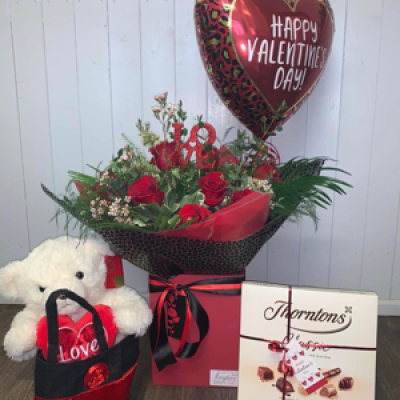 Say I Love You - Say I Love You with a gift package of a dozen red roses aqua hand tied bouquet, Teddy in a satin bag, Deluxe Chocolates & a Balloon. Show them how much you care, this Valentine’s Day. 