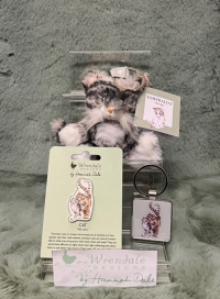 Wrendale Cat Accessories - These accessories will be the paw-fect addition to your keys or outfit! 
They make a great treat for yourself or someone special. 
The wonderful cat pin badge will add an extra flourish to your jacket, scarf and bag or pin board. 
Never lose your keys again with these delightful keyrings. A simple yet adorable metal keyring or a stand out gorgeous plush animal. 
*PLEASE SELECT THE PRICE *
*STANDARD- CAT PIN*
*DELUXE- CAT KEYRING(METAL)*
*LUXURY- PLUSH CAT KEYRING*
*ITEM IS ONLY AVAILABLE AS AN ADD ON GIFT OR FOR COLLECTION*
*LIMITED AVAILABILITY*
Pin badge details- Badge 35mm, backing card 105mmx75mm.  Each pin badge comes on information card with a to/from section on the back. Made from alloy with a silver finish. Nickle free and card made from sustainable sourced board. 
Metal keyring details- 4cmx8cm including the ring. Cast in hard wearing zinc alloy metal with a resin domed finish on the front.
Plush keyring- Measures 105mm x 80mm x 70mm. Finished with a branded woven label and a silver keyring loop perfect for attaching to keys and bags. Made with quality soft and tactile materials with polyester fiber stuffing. Recommended for children 3 years +.