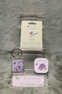 Wrendale Bee Accessories - These accessories will be the perfect addition to your keys or outfit! 
They make a great treat for yourself or someone special. 
The wonderful bee pin badge will add an extra flourish to your jacket, scarf and bag or pin board. 
Never lose your keys again with a simple yet adorable metal keyring
 
Keep your lips moisturised and nourished with this delicate lip balm in illustrated tin. The hydrating lip balm has a sweet scent of honey and vanilla. 
*PLEASE SPECIFIED ITEM IN ORDER DESCRIPTION *
*ITEM IS ONLY AVAILABLE AS AN ADD ON GIFT OR FOR COLLECTION*
*LIMITED AVAILABILITY*
Pin badge details- Badge 35mm, backing card 105mmx75mm.  Each pin badge comes on information card with a to/from section on the back. Made from alloy with a silver finish. Nickle free and card made from sustainable sourced board. 
Metal keyring details- 4cmx8cm including the ring. Cast in hard wearing zinc alloy metal with a resin domed finish on the front.
Lip balm details - Measures 45mm x 45mm x 15mm.Made in the UK. 100% cruelty free. Enriched with shea butter. Paraben & SLS free.
